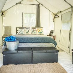 Cozy and comfortable bedroom in the glamping tent where you can fall asleep listening to the sound of the creek and waterfall.